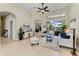 Bright living room with neutral tones, tile floors, and views of the outdoor living space at 8103 Snowy Egret Pl, Bradenton, FL 34202