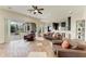 Spacious living room features an open floor plan, tile floors, and seamless transition to the outdoor screened patio at 8103 Snowy Egret Pl, Bradenton, FL 34202