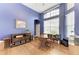 Bright office with hardwood floors, blue accent wall, large windows, and built-in shelving at 8103 Snowy Egret Pl, Bradenton, FL 34202
