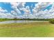 Scenic view of pond surrounded by greenery and grass at 8103 Snowy Egret Pl, Bradenton, FL 34202