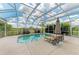 Enjoy the outdoors by this serene pool area surrounded by a screened enclosure at 8103 Snowy Egret Pl, Bradenton, FL 34202