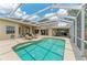 Beautiful screened pool area with lounge chairs, dining, and well manicured landscaping at 8103 Snowy Egret Pl, Bradenton, FL 34202