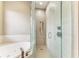 Glass enclosed shower with white and grey tiling and modern fixtures at 8103 Snowy Egret Pl, Bradenton, FL 34202
