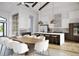 Open-concept kitchen with a large island, counter seating, and stainless steel appliances at 838 Norsota Way, Sarasota, FL 34242