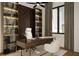 Stylish home office with built-in shelving, a modern desk, and a comfortable executive chair at 838 Norsota Way, Sarasota, FL 34242