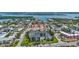 An aerial view showcasing the community, with lush landscaping, waterways, and a community pool at 845 Benjamin Franklin Dr # 302, Sarasota, FL 34236