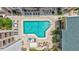 An aerial view of pool and amenity areas includes lounge chairs, tables and manicured landscaping at 845 Benjamin Franklin Dr # 302, Sarasota, FL 34236