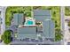 Aerial view of a residential complex, showcasing its lush landscaping, pool, and parking areas at 845 Benjamin Franklin Dr # 302, Sarasota, FL 34236