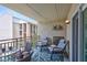Relaxing balcony featuring comfortable chairs, a table set for two, and nautical decorations at 845 Benjamin Franklin Dr # 302, Sarasota, FL 34236