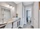 Stylish bathroom with modern vanity, decorative mirror, and updated fixtures at 845 Benjamin Franklin Dr # 302, Sarasota, FL 34236