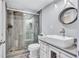 Bathroom featuring a shower with glass doors, river rock shower pan, vessel sink, and stylish finishes at 845 Benjamin Franklin Dr # 302, Sarasota, FL 34236