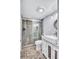 Bathroom featuring a shower with glass doors, river rock shower pan, vessel sink, and stylish finishes at 845 Benjamin Franklin Dr # 302, Sarasota, FL 34236