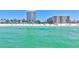Beautiful beachfront with turquoise water and white sand near hotel and resort buildings at 845 Benjamin Franklin Dr # 302, Sarasota, FL 34236