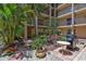 Outdoor patio with barbeque grill, seating, landscaping and a courtyard view at 845 Benjamin Franklin Dr # 302, Sarasota, FL 34236
