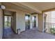 Building access featuring elevators and exterior walkways with tropical landscaping at 845 Benjamin Franklin Dr # 302, Sarasota, FL 34236