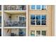 Building exterior showing balcony with seating, complemented by swimming pool and palm tree reflections at 845 Benjamin Franklin Dr # 302, Sarasota, FL 34236