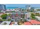 Condo building is close to the beach with a parking lot and tropical trees at 845 Benjamin Franklin Dr # 302, Sarasota, FL 34236