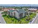 Landscaped condo building, with lawn and palm trees at 845 Benjamin Franklin Dr # 302, Sarasota, FL 34236