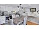An open kitchen and dining area with stainless appliances, white cabinets, and unique chandelier lighting at 845 Benjamin Franklin Dr # 302, Sarasota, FL 34236