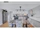 An open kitchen and dining area with stainless appliances, white cabinets, and unique chandelier lighting at 845 Benjamin Franklin Dr # 302, Sarasota, FL 34236