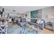 Open living area with a spacious sofa, artwork, and seamless access to the modern kitchen and dining area at 845 Benjamin Franklin Dr # 302, Sarasota, FL 34236