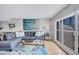 Comfortable living room with a gray sectional sofa, natural light, stylish decor, and hardwood flooring at 845 Benjamin Franklin Dr # 302, Sarasota, FL 34236