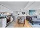 Stylish living area with a cozy seating arrangement and a modern kitchen setup, enhanced by natural light at 845 Benjamin Franklin Dr # 302, Sarasota, FL 34236