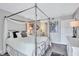 Serene main bedroom with a four-poster bed, decorative interior, and stylish furnishings at 845 Benjamin Franklin Dr # 302, Sarasota, FL 34236