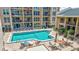 Outdoor pool and patio with chairs and tables at 845 Benjamin Franklin Dr # 302, Sarasota, FL 34236