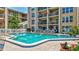 Enjoy this outdoor swimming pool with comfortable lounge chairs and tables for relaxation at 845 Benjamin Franklin Dr # 302, Sarasota, FL 34236