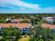 Scenic aerial view of a charming community with lush landscaping and serene pond at 850 S Tamiami Trl # 431, Sarasota, FL 34236