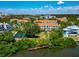 Stunning aerial view of condo community with beautiful pond, lush landscaping, and city views at 850 S Tamiami Trl # 431, Sarasota, FL 34236