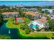 Stunning aerial view of community featuring a pool, tennis court, lake, and city skyline at 850 S Tamiami Trl # 431, Sarasota, FL 34236
