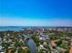 High-angle view showcases an expanse of land, waterways, and modern city buildings on the horizon at 850 S Tamiami Trl # 431, Sarasota, FL 34236