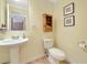 Bathroom featuring a pedestal sink, tile flooring, and framed artwork at 850 S Tamiami Trl # 431, Sarasota, FL 34236