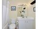 Bright bathroom featuring a white vanity with a mirror and a boat themed artwork above toilet at 850 S Tamiami Trl # 431, Sarasota, FL 34236