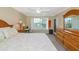 Cozy bedroom features a queen bed, wood furniture, and bright window with shutters at 850 S Tamiami Trl # 431, Sarasota, FL 34236