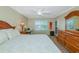 Cozy bedroom with a queen bed, dresser, shutters and an exterior door at 850 S Tamiami Trl # 431, Sarasota, FL 34236