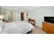 Bright bedroom with ceiling fan, and doors leading to bathroom and closet at 850 S Tamiami Trl # 431, Sarasota, FL 34236