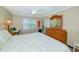 Cozy bedroom features a queen bed, wood furniture, and bright window with shutters at 850 S Tamiami Trl # 431, Sarasota, FL 34236