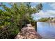 Enjoy the serene water view and relaxation on the community dock with built in bench at 850 S Tamiami Trl # 431, Sarasota, FL 34236