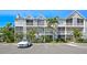 Beautiful multi-Gathering exterior featuring screened balconies, lush landscaping, and ample parking at 850 S Tamiami Trl # 431, Sarasota, FL 34236