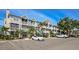 Attractive condo building with well-manicured landscaping and ample parking on a sunny day at 850 S Tamiami Trl # 431, Sarasota, FL 34236