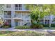 Exterior shot of a condo building with two stories, tropical landscaping and plenty of green space at 850 S Tamiami Trl # 431, Sarasota, FL 34236