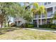 Exterior of property with tropical landscaping, side staircases, and balconies at 850 S Tamiami Trl # 431, Sarasota, FL 34236
