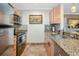 Kitchen area featuring stainless steel appliances, granite countertops, and tile flooring at 850 S Tamiami Trl # 431, Sarasota, FL 34236