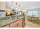 Open concept kitchen with granite counters and stainless steel appliances at 850 S Tamiami Trl # 431, Sarasota, FL 34236