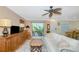 Bright living room with sliding glass doors to balcony, comfortable seating, and tile floors at 850 S Tamiami Trl # 431, Sarasota, FL 34236