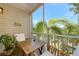 Screened patio featuring a table, chairs, and tropical views at 850 S Tamiami Trl # 431, Sarasota, FL 34236