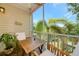 Screened patio featuring a table, chairs, and tropical views at 850 S Tamiami Trl # 431, Sarasota, FL 34236